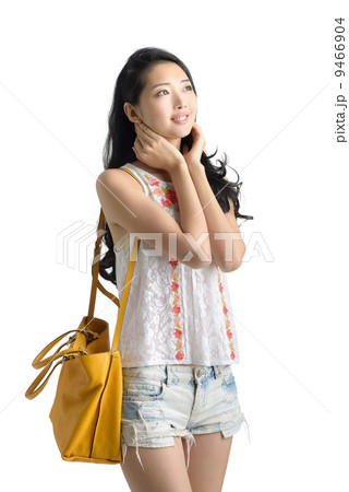 Teenage girl sleeveless top denim shorts casual wear studio in isolated white background  9466904