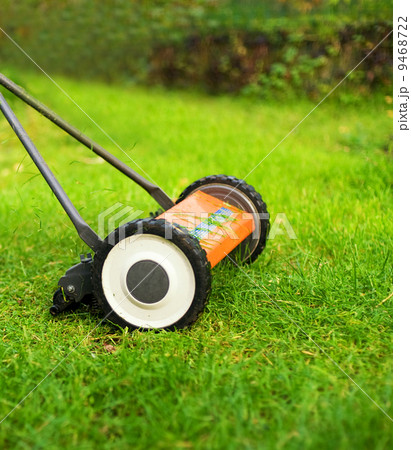 Lawnmower cutting grass 9468722