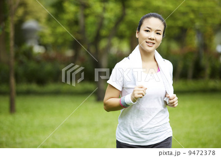 Beautiful asian woman jogging in the park Beautiful asian woman jogging in the park 9472378