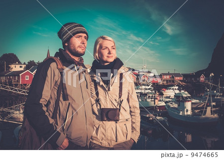 Young travellers couple in Reine village, Norway Young travellers couple in Reine village, Norway 9474665