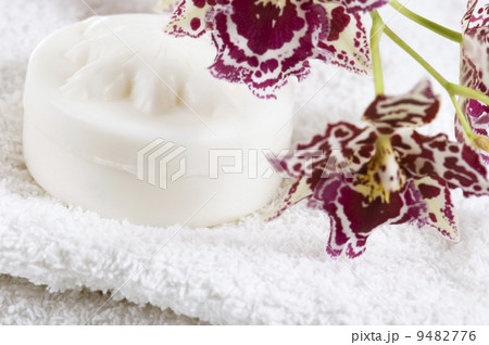 Spa items with white towels, natural soap and orchid 9482776