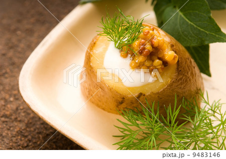 Baked potato with sour cream, grain Dijon mustard and herbs Baked potato with sour cream, grain Dijon mustard and herbs 9483146