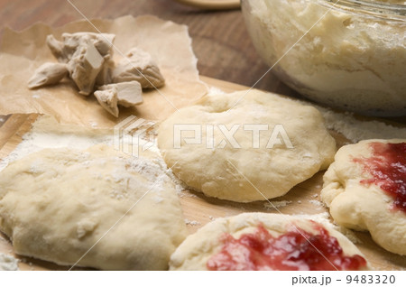 Dough with marmelade on wooden board 9483320