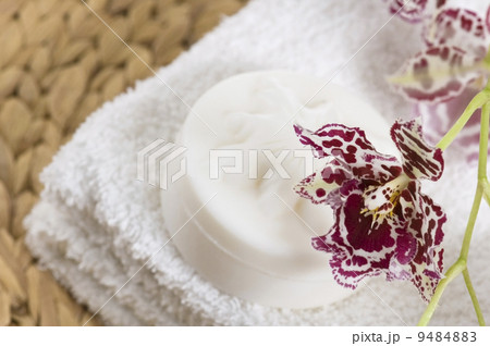 Spa items with white towels, natural soap and orchid 9484883