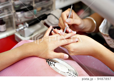 Manicure process on female hand Manicure process on female hand 9487897