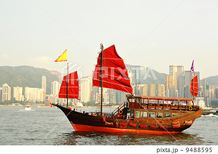 Hong Kong harbor with red sail boat 9488595