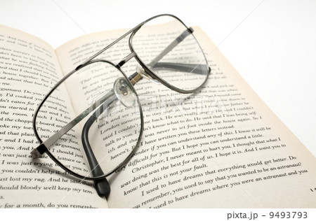 closeup of opened book and glasses. 9493793