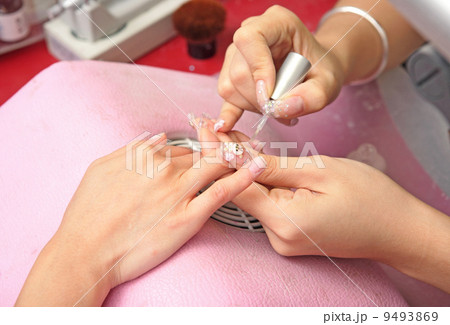 manicure process on female hand 9493869