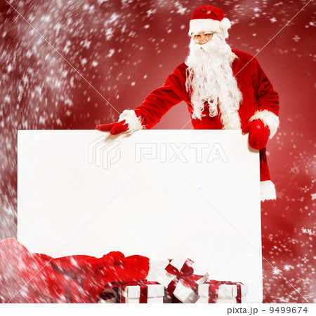 Santa Claus with sack full of gift boxes and blank notice board 9499674