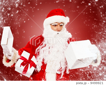 Surprised Santa Claus with opened gift box Surprised Santa Claus with opened gift box 9499921