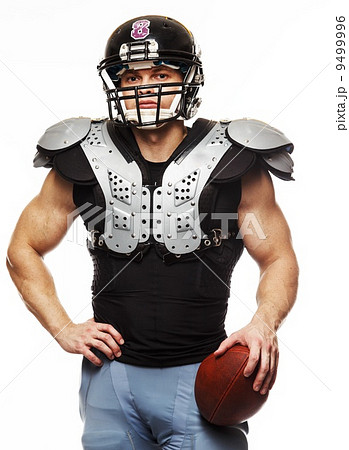 American football player with ball wearing helmet and protective shields American football player with ball wearing helmet and protective shields 9499996
