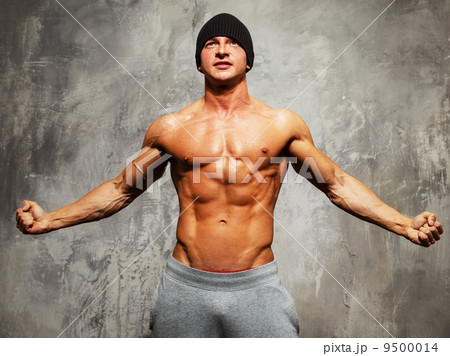 Handsome man with muscular torso in beanie hat posing Handsome man with muscular torso in beanie hat posing 9500014