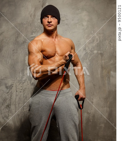 Handsome man with muscular body doing fitness exercise Handsome man with muscular body doing fitness exercise 9500121