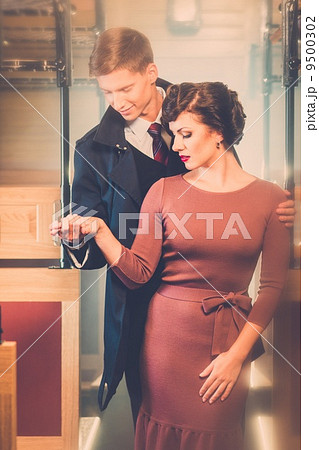 Beautiful vintage style couple inside retro train coach Beautiful vintage style couple inside retro train coach 9500302