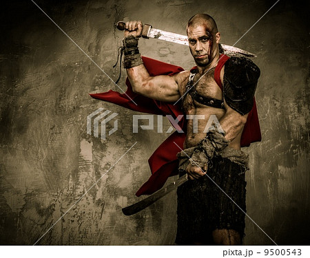 Wounded gladiator with two swords covered in blood Wounded gladiator with two swords covered in blood 9500543