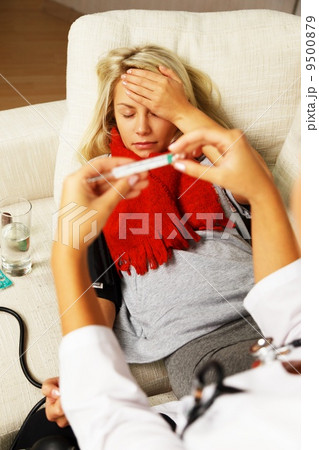 Female doctor measuring sick girl's blood pressure and temperature Female doctor measuring sick girl's blood pressure and temperature 9500879