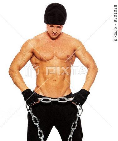 Handsome muscular man in beanie hat with chain Handsome muscular man in beanie hat with chain 9501028