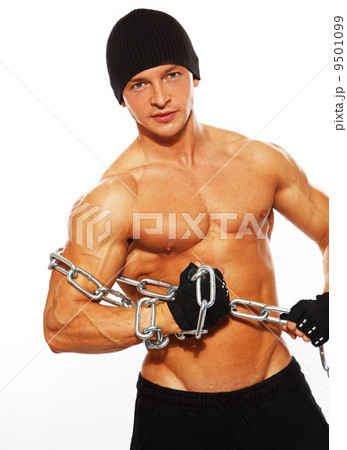 Handsome muscular man in beanie hat with chain 9501099