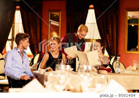 Group of young friends with choosing in a luxury restaurant 9501404