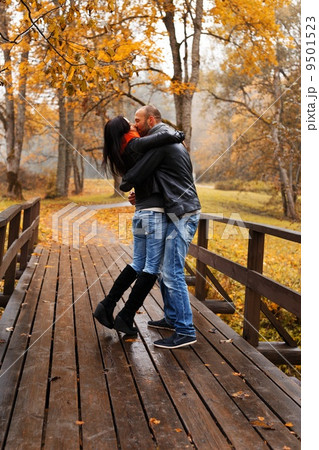 Happy middle-aged couple kissing outdoors on beautiful autumn day Happy middle-aged couple kissing outdoors on beautiful autumn day 9501523