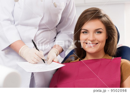 Young brunette woman with beautiful smile visiting dentist 9502098