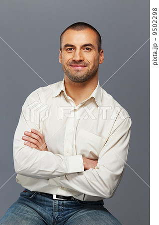 Handsome man in white shirt isolated on grey background 9502298