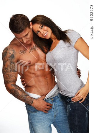Young woman embracing man with naked muscular torso Young woman embracing man with naked muscular torso 9502578