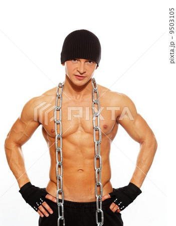 Handsome muscular man in beanie hat with chain 9503105