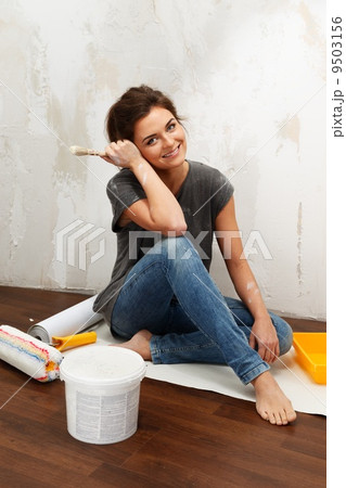 Happy beautiful young woman doing wall painting Happy beautiful young woman doing wall painting 9503156