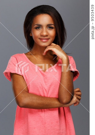Cheerful young black woman isolated on grey background 9503439
