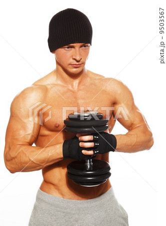 Handsome young muscular man exercising with dumbbells 9503567