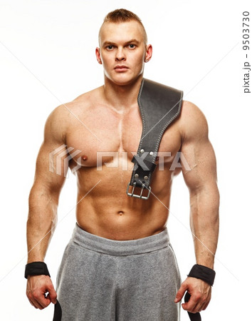 Muscular young sportsman with weight lifting belt Muscular young sportsman with weight lifting belt 9503730