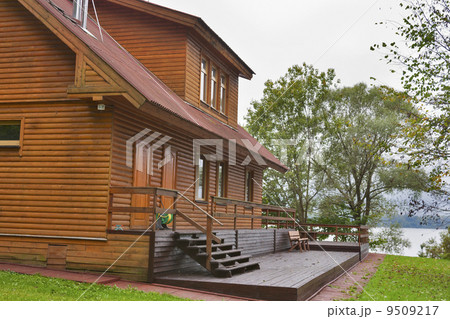 country wooden house close to lake 9509217