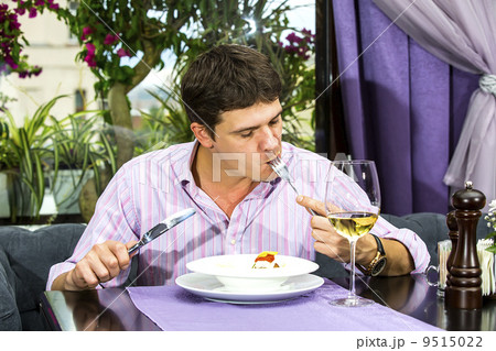 one young man having dinner in a restaurant 9515022