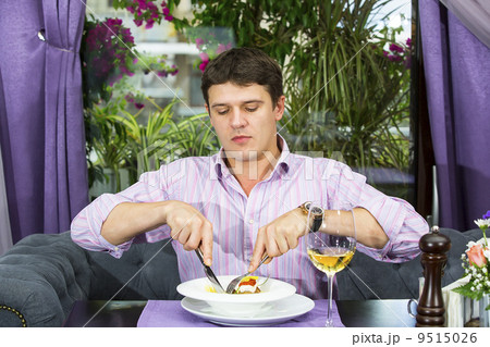 one young man having dinner in a restaurant one young man having dinner in a restaurant 9515026