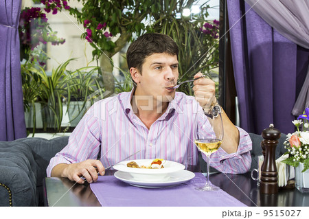 one young man having dinner in a restaurant one young man having dinner in a restaurant 9515027
