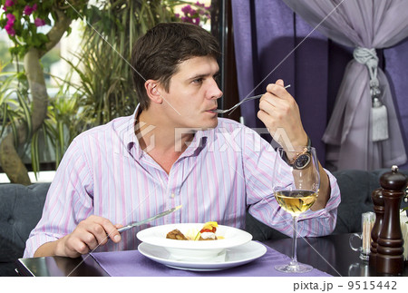one young man having dinner in a restaurant one young man having dinner in a restaurant 9515442