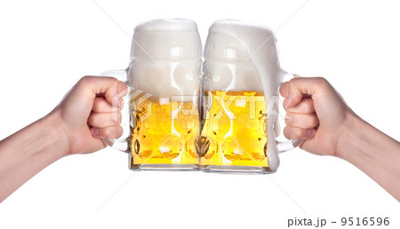 two hands holding beers making a toast 9516596