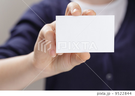female teen holding empty business card in front of camera 9522844