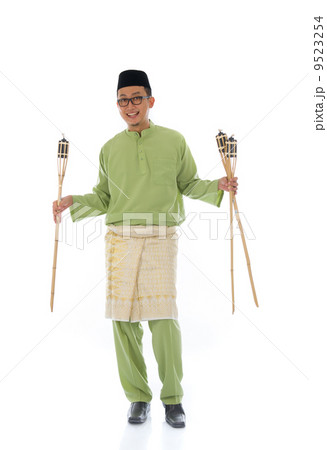 Malay male celebrating hari raya with oil lamp and isolated whit 9523254