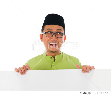 malay male with blank card during hari raya Eid al-Fitr celebrat 9523272