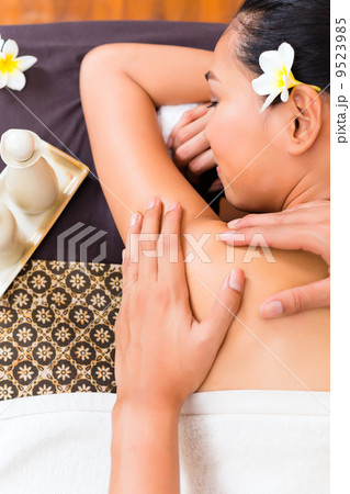 Indonesian Asian woman at wellness spa massage Indonesian Asian woman at wellness spa massage 9523985