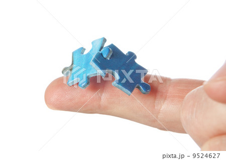 Connecting two puzzles on your finger. On a white background. 9524627