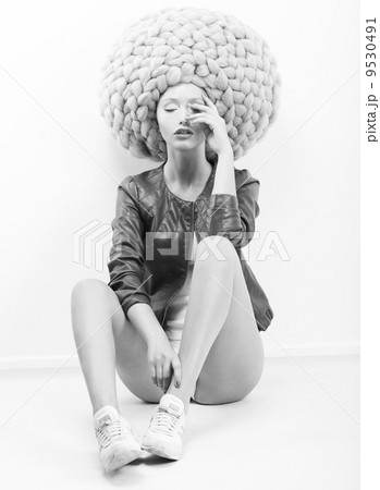 Art Modern. Futuristic Woman in Trendy Huge Lust Wig with Braids 9530491