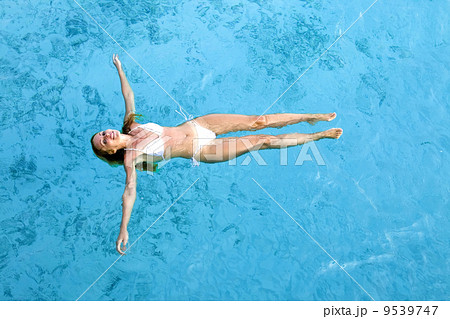 Young woman smiles, swiming in ocean, Maldives.. 9539747