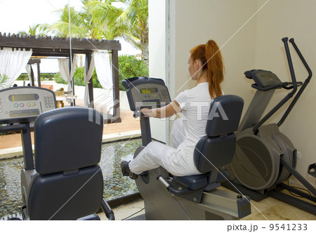 Young sports woman in sport center on velosimulator 9541233