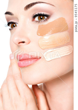 Beautiful face of woman with cosmetic foundation on a skin. Beautiful face of woman with cosmetic foundation on a skin. 9545175