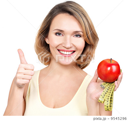 Portrait of a beautiful young woman with a measuring tape and ap 9545296