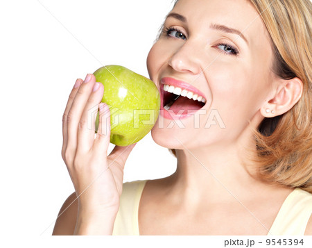 Beautiful young woman biting the biting a fresh ripe apple Beautiful young woman biting the biting a fresh ripe apple 9545394