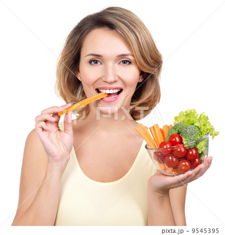 Beautiful young healthy woman eating a salad. 9545395